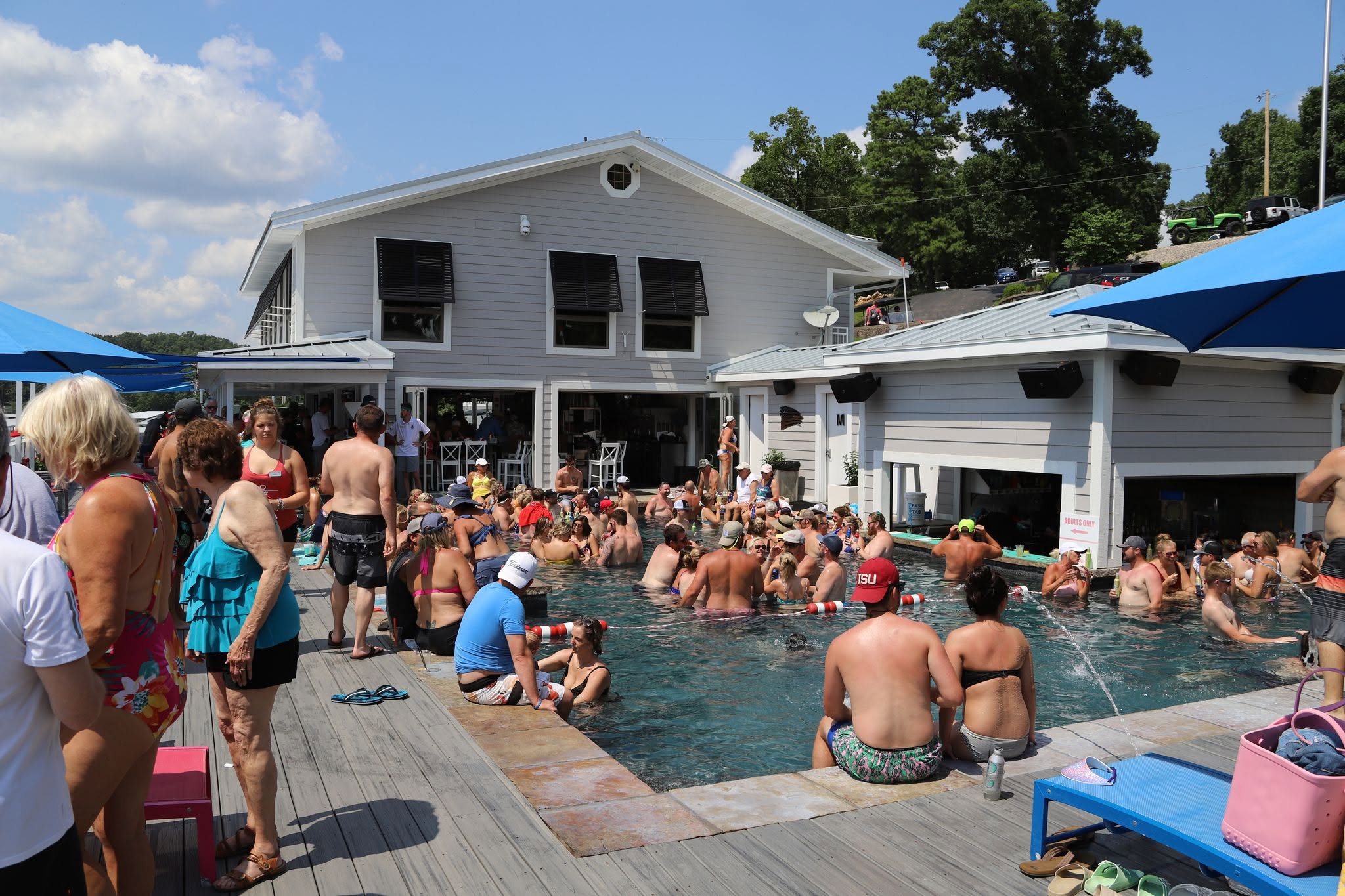 A lively summer crowd gathered around the Boathouse pool