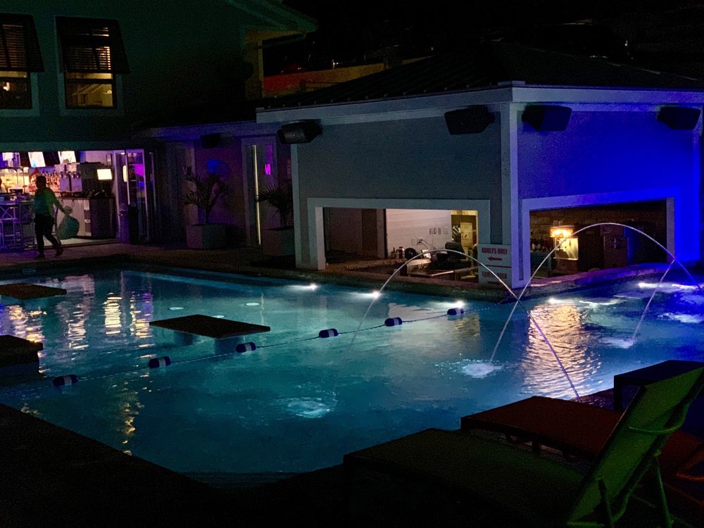 The Boathouse pool glowing blue after dark